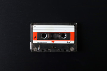 Old tape cassette, old or aged wood background. İsolated casette