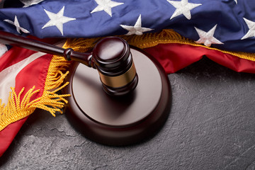 Top view of gavel on background of American flag on black background