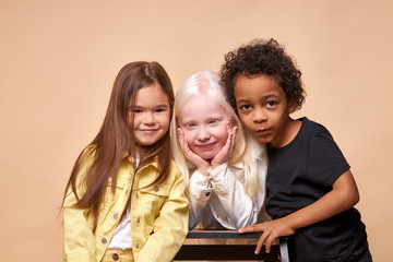 happy smiling kids isolated in studio, albino,afro american and european children laugh, smile at...