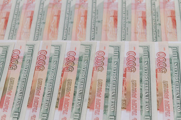 A large number of American hundred dollar bills and Russian five thousand dollar bills