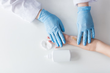 Fototapeta premium doctor puts a Band-Aid on his hand