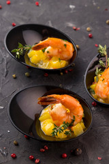 
Buffet menu in disposable utensils from a catering company. On a dark background