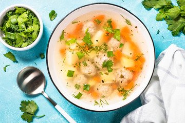 Meatballs soup with vegetables top view.