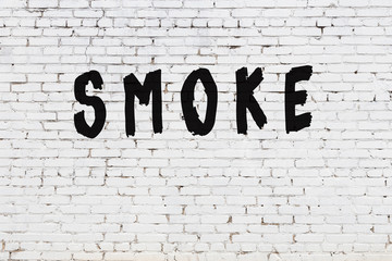 White wall with black paint inscription smoke on it © iushakovsky