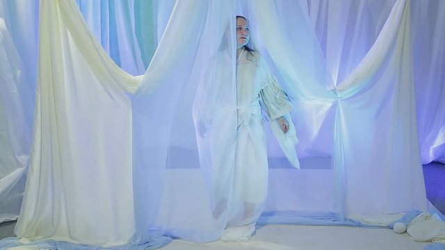 Young Jewish bride rehearsing an exit under the chuppah before the wedding.