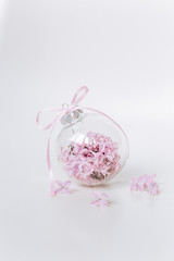 Obraz na płótnie Canvas glass vase round lilac flowers gift bow