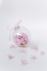 Fototapeta na wymiar glass vase round lilac flowers gift bow