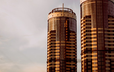 two skyscraper building sunset background sky clouds