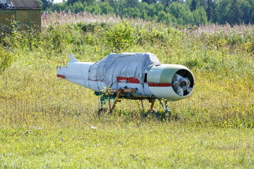 the remains of an old aircraft stand in a meadow on a Sunny summer day