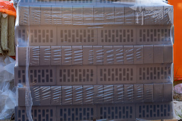 Brick face ceramic hollow single in a pallet covered with a plastic film