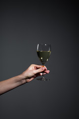 Hand holding a glass of white wine