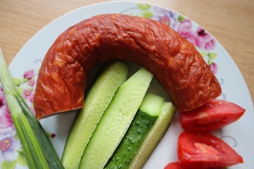 Breakfast sausage cucumbers and tomatoes on a plate