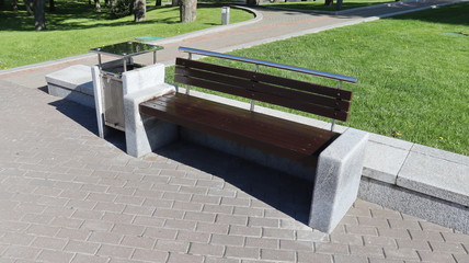 modern bench in park on concrete ground