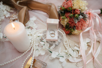 Wedding rings and other accessories close-up during the bride's gathering. Wedding