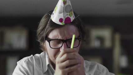 Sad manager celebrating a lonely birthday in the office