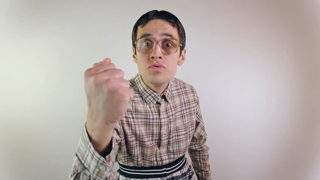 Funny threatening guy with fists raised staring at camera