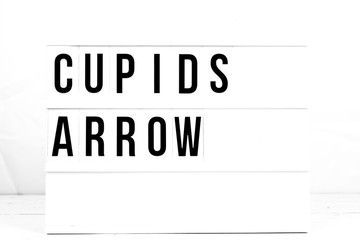 Modern Cupids Arrow Sign on Retro Quote Board. Romantic