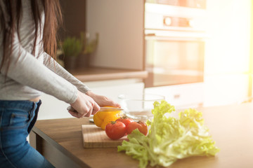 Young trendy woman cooking healthy food in the morning