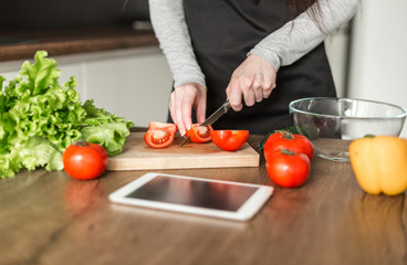 Young trendy woman cooking healthy food in the morning
