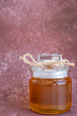 Composition with fresh honey on maroon background