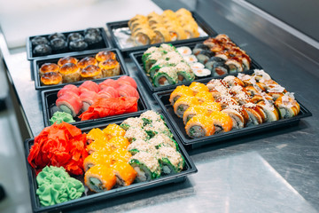 Sushi delivery. Many varieties of Sushi in a plastic box are prepared for delivery.