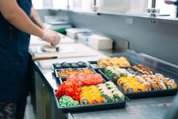 Sushi delivery. Many varieties of Sushi in a plastic box are prepared for delivery.