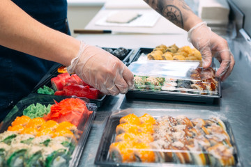 Sushi delivery. Many varieties of Sushi in a plastic box are prepared for delivery.