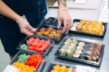 Sushi delivery. Many varieties of Sushi in a plastic box are prepared for delivery.