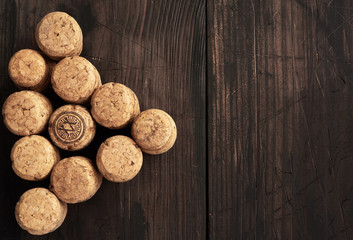 stack of corks for glass wine and champagne bottles on wooden background, copy space