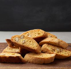 pieces of baked italian christmas biscotti cookies on a brown wooden board