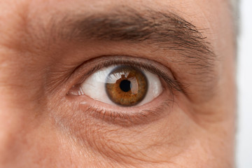 open eye on the face of an adult man with wrinkles