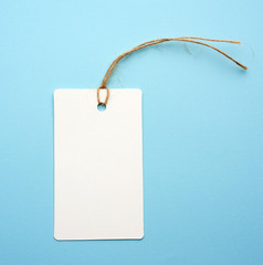 Blank white paper tag with white rope on a blue background