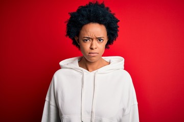 Fototapeta na wymiar Young beautiful African American afro sportswoman with curly hair wearing sportswear skeptic and nervous, frowning upset because of problem. Negative person.