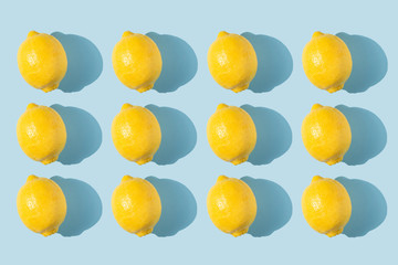 Pattern of lemons with shadow on a blue background. Healthy eating concept. Fresh bright fruits....