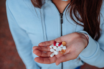 Coronavirus. Covid-19. A man or woman takes and shows pills.