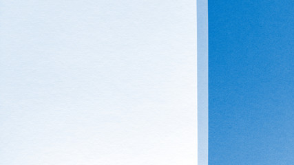 Simple flat lay with pastel texture. Blue and white paper background. Stock photo.