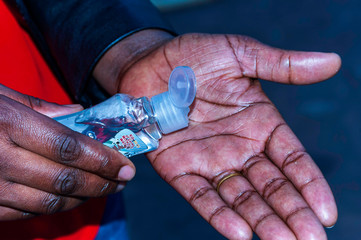 Applying hand sanitizer to prevent corona-virus and other infectious bacteria.