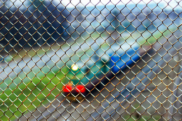 the locomotive moves along the railway tracks, behind the mesh, top view, blurred background