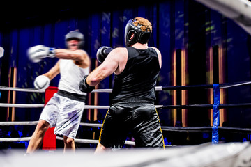 Amateur fight in a boxing ring, big swing