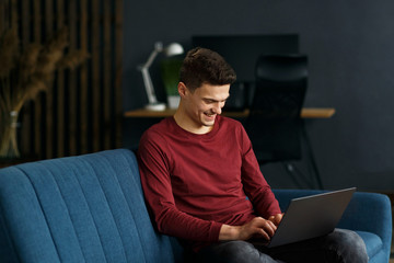 Young freelancer working in home with laptop. Texting messages, browsing internet. Studying online, online education, remote working. Young people working at home. Business concept.