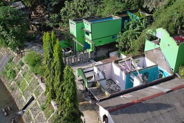 Residents' houses that have been forced to be demolished because they occupy illegal land leaving walls and floors