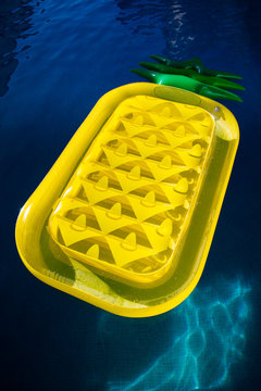 High Angle View Of Yellow Raft Floating On Swimming Pool