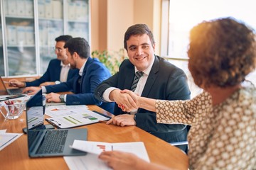 Business lawyers workers meeting at law firm office. Professional executive partners working on finance strategry at the workplace. Shaking hands for succesful agreement.