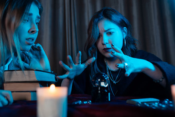 Woman and woman fortune teller with crystal ball
