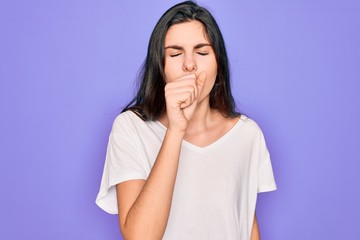 Young beautiful brunette woman wearing casual white t-shirt over purple background feeling unwell and coughing as symptom for cold or bronchitis. Health care concept.