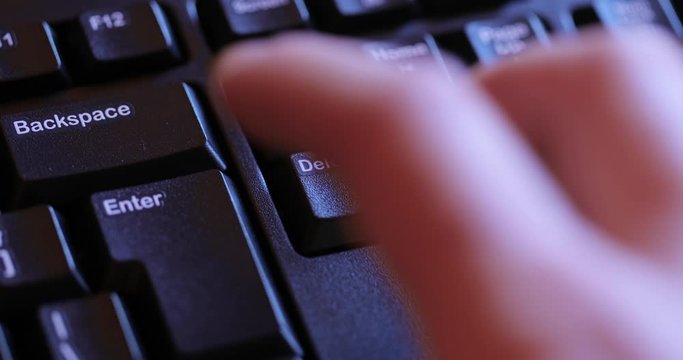 Hitting the Delete key and Enter several times on a computer keyboard, deleting files