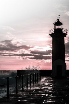 Felgueiras Lighthouse at sunset in stormy weather, Portugal