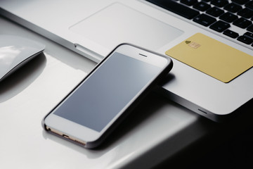 Laptop and phone with black screen on the table