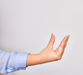 Hand of caucasian young woman doing catch sign over isolated white background