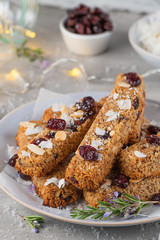 Granola bar. Healthy snack. Cereal granola bar with nuts, fruit, coconut and cranberries on a christmas table